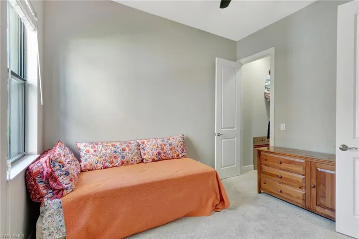 Bedroom featuring a ceiling fan and light carpet