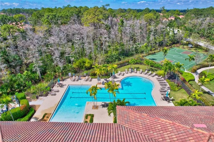 Pool featuring community basketball court, fence, and a patio