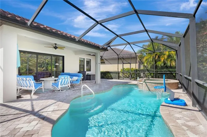 View of swimming pool with a patio, a pool with connected hot tub, a ceiling fan, a lanai, and an outdoor living space
