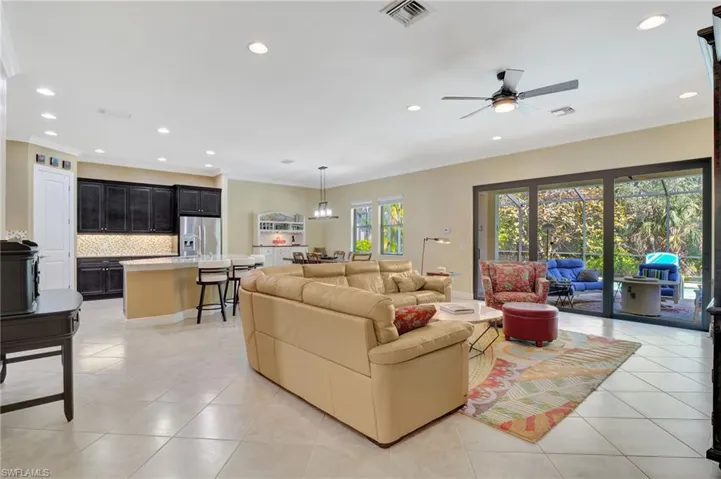 Living area featuring recessed lighting, visible vents, crown molding, and light tile patterned flooring