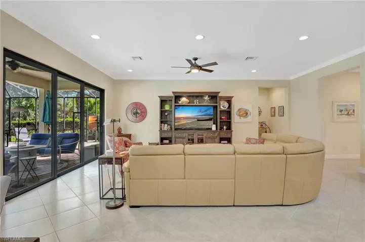 Living room featuring visible vents and crown molding