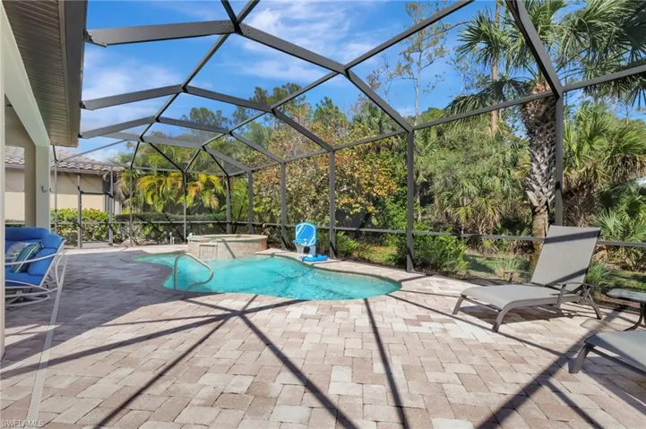 View of swimming pool with a patio area, a lanai, and a pool with connected hot tub