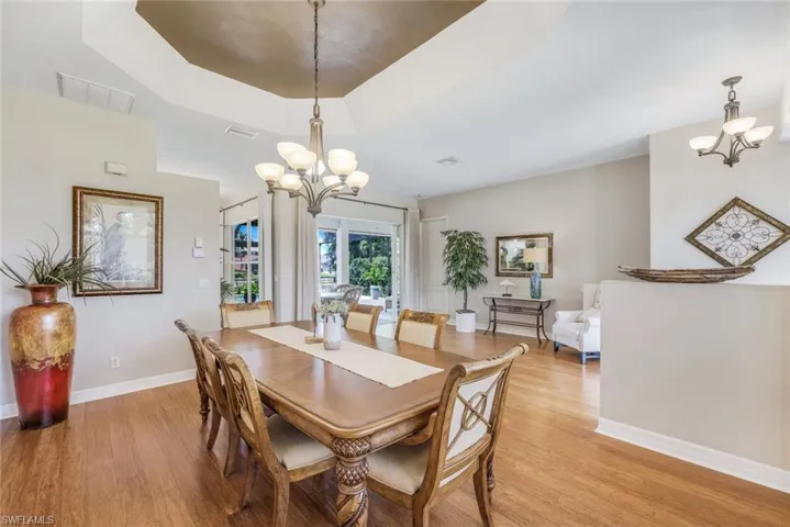 Formal dining room with tray ceiling & bamboo floors