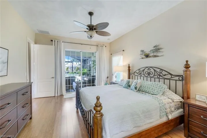 Large master bedroom with bamboo floors and sliders leading to your awesome pool area