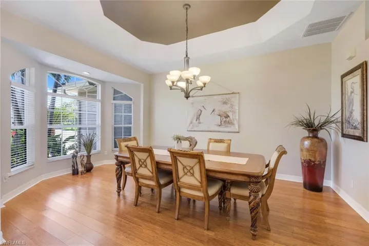 Large formal dining room with tray ceiling