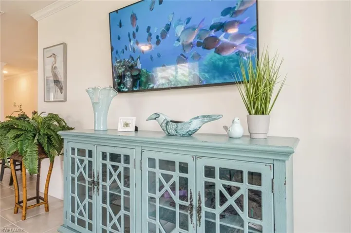 Room details with tile patterned floors and crown molding