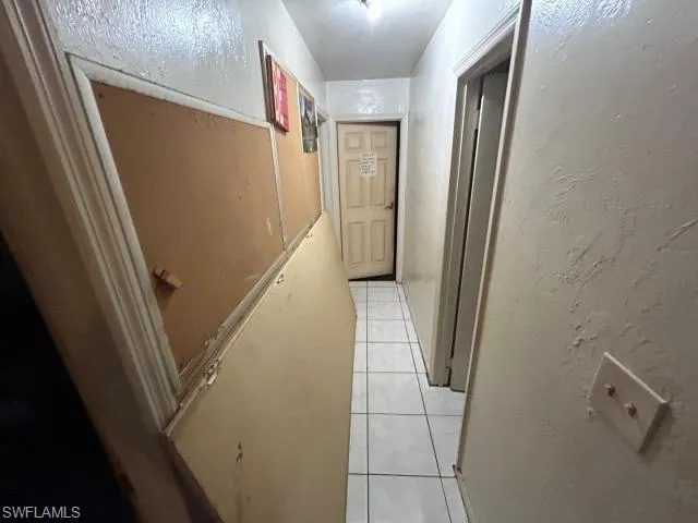Corridor featuring light tile patterned floors