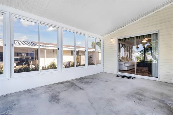 Unfurnished sunroom featuring a healthy amount of sunlight and lofted ceiling