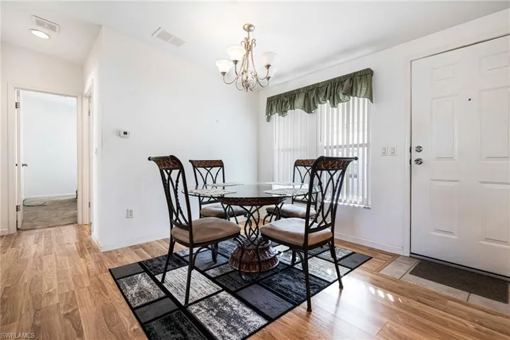 Dining room featuring light hardwood / wood-style flooring and a notable chandelier