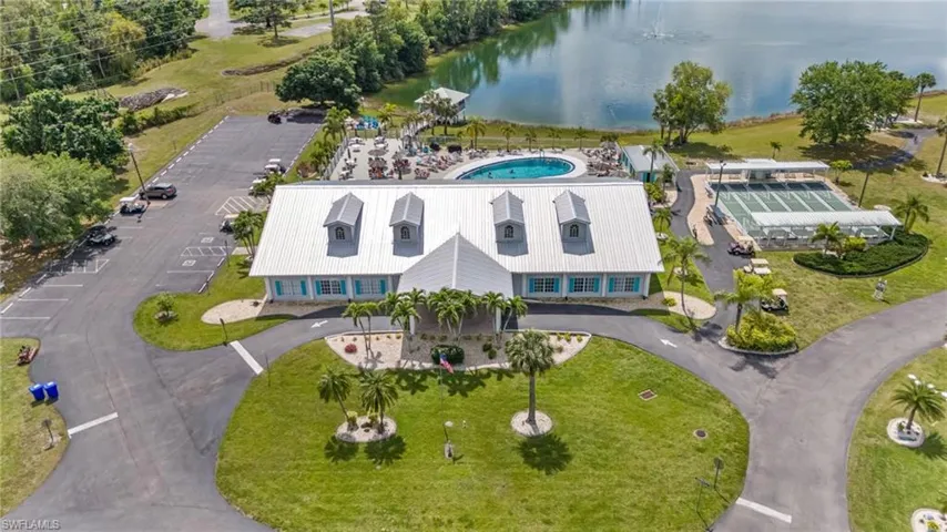 Birds eye view of property with a water view