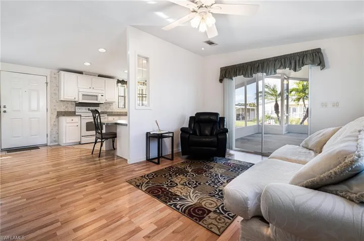 Living room featuring light hardwood / wood-style flooring and ceiling fan
