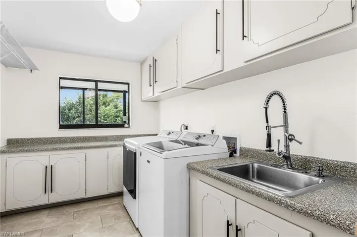 'approx 15'9" x 7'10"cabinets, laminate counter tops, sink, ceramic tile floor, closet for water heater, also a door that leads to hallway to exterior side door to garage