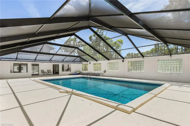 Very large enclosed pool, plenty of space for lounge chairs. Per county records, pool is 18'x31' - per county enclosure is 55' x 38'