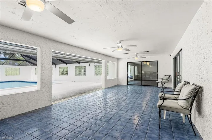 Tiled lanai is approx 33'x13'8".  There is water and electric on wall by hallway for a future outdoor kitchen, there is a counter grill and metal drawers, patio table