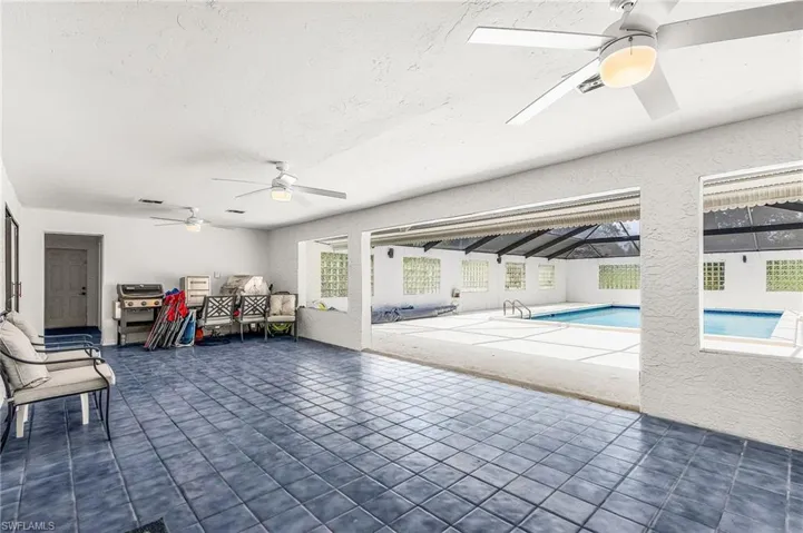 Tiled lanai is approx 33'x13'8".  There is water and electric on wall by hallway for a future outdoor kitchen, there is a counter grill and metal drawers, patio table