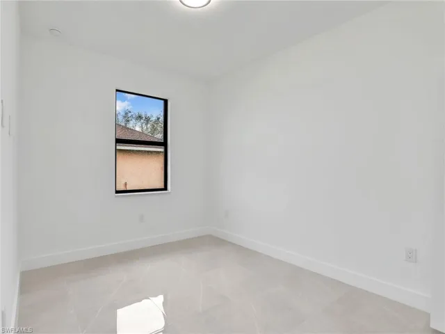 Unfurnished room featuring baseboards