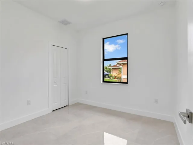 Empty room featuring baseboards and visible vents