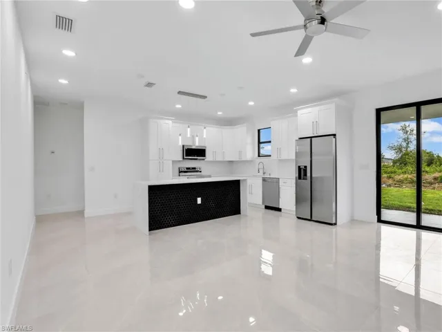 Kitchen featuring visible vents, a sink, recessed lighting, appliances with stainless steel finishes, and light countertops
