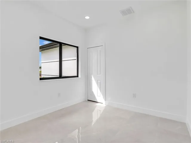 Empty room featuring recessed lighting, visible vents, and baseboards