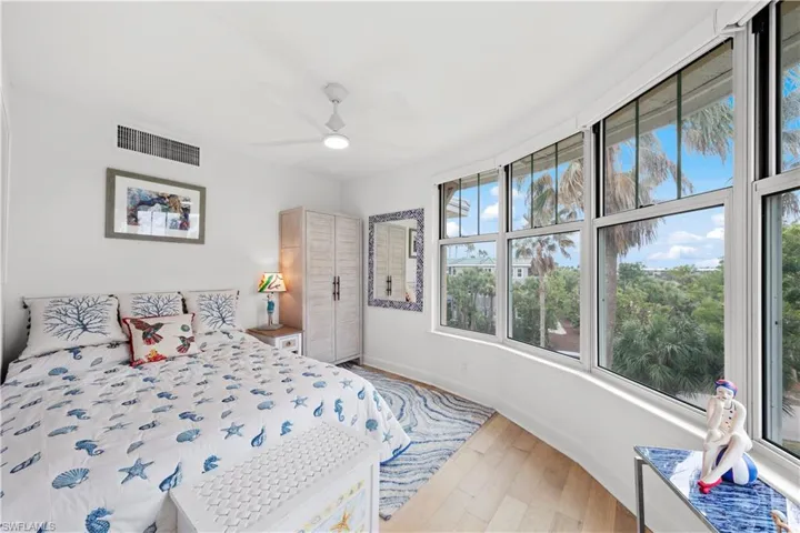 Bedroom with ceiling fan and wood-type flooring
