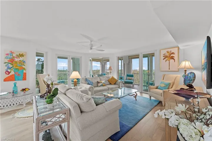 Living room with light hardwood / wood-style flooring and ceiling fan