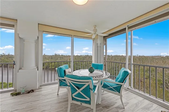 Sunroom / solarium featuring ceiling fan and a healthy amount of sunlight