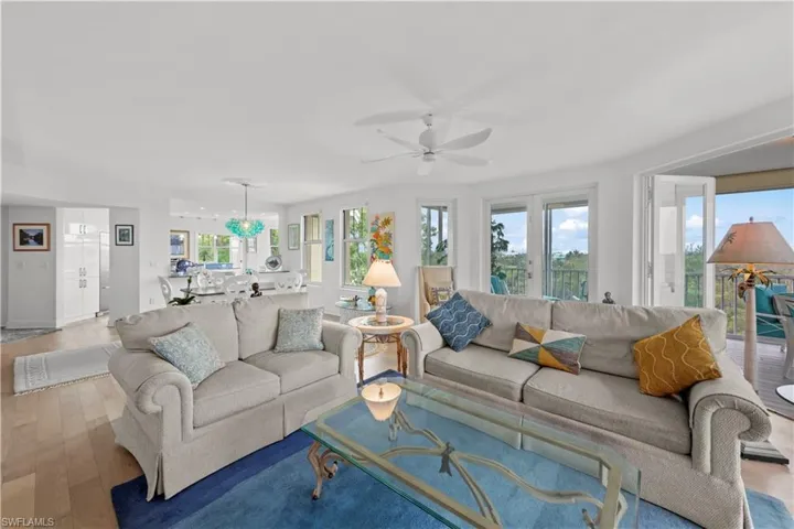 Living room featuring light wood-type flooring and ceiling fan