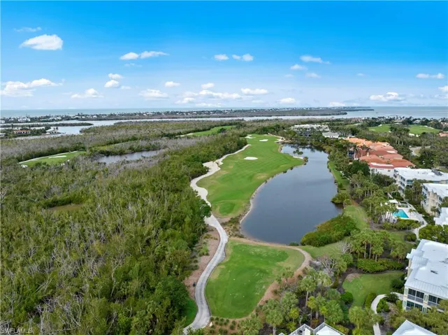 Birds eye view of property with a water view