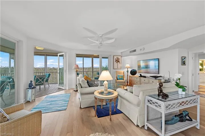 Living room with light wood-type flooring and ceiling fan
