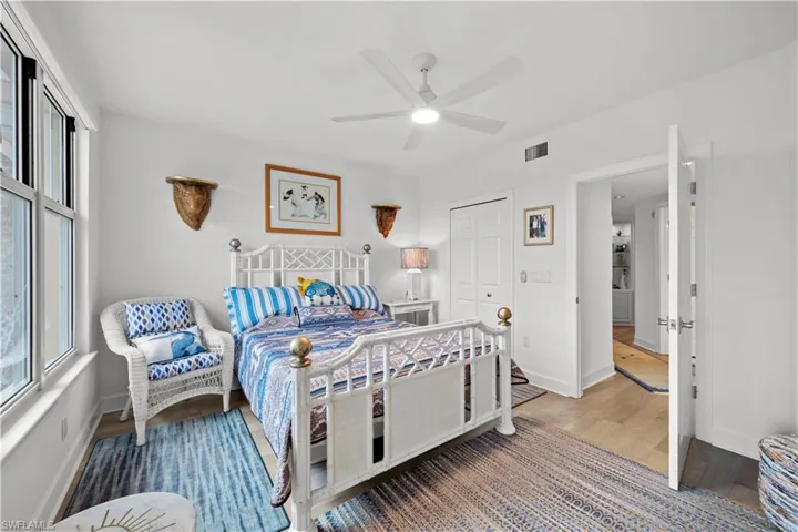 Bedroom featuring a closet, ceiling fan, and wood-type flooring