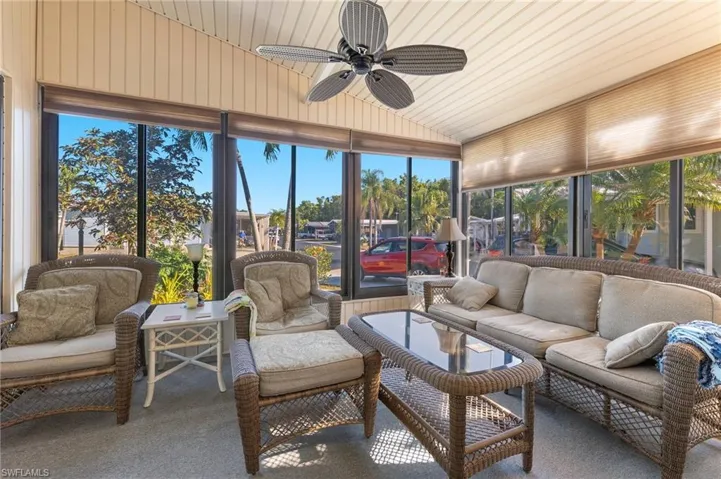 Sunroom / solarium featuring a ceiling fan and lofted ceiling