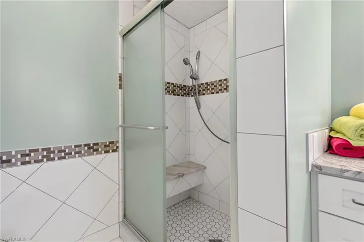 Bathroom featuring a stall shower and vanity