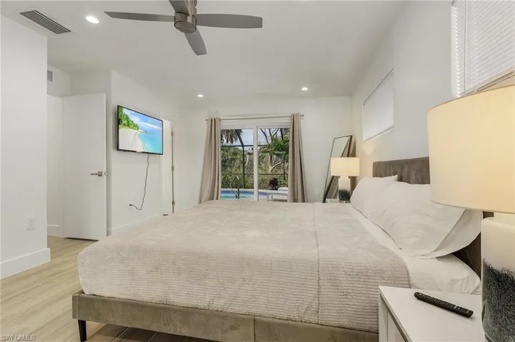 Bedroom featuring recessed lighting, light wood-type flooring, ceiling fan, and access to outside
