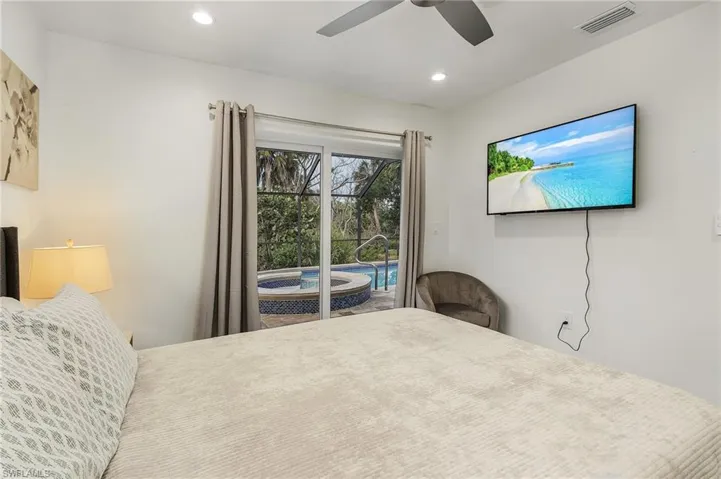 Bedroom with access to outside, a ceiling fan, and recessed lighting