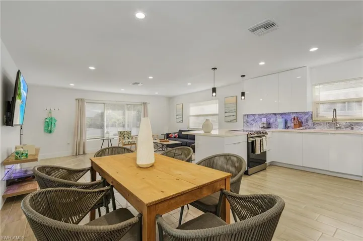 Dining space with light wood-style floors, plenty of natural light, and recessed lighting