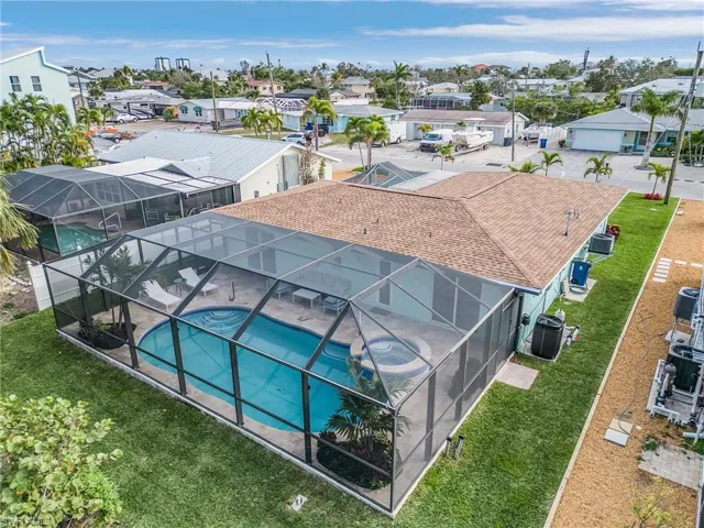 Aerial view of residential area featuring a pool