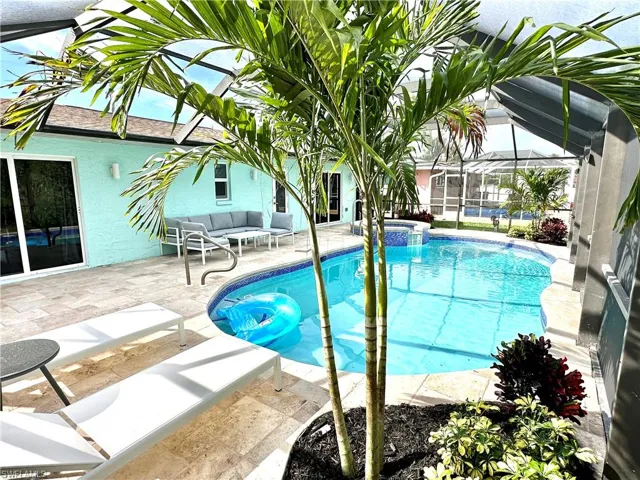 View of swimming pool with a patio area, a sunroom, a lanai, and a pool with connected hot tub