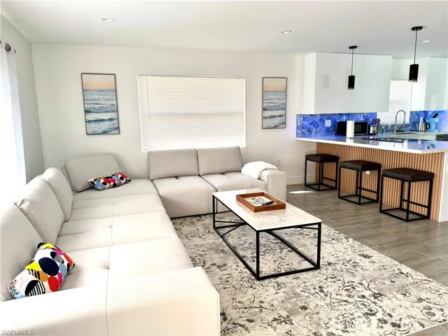 Living room featuring light wood-style flooring and recessed lighting