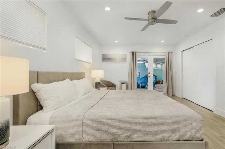 Bedroom featuring french doors, access to outside, a ceiling fan, light wood-style floors, and recessed lighting