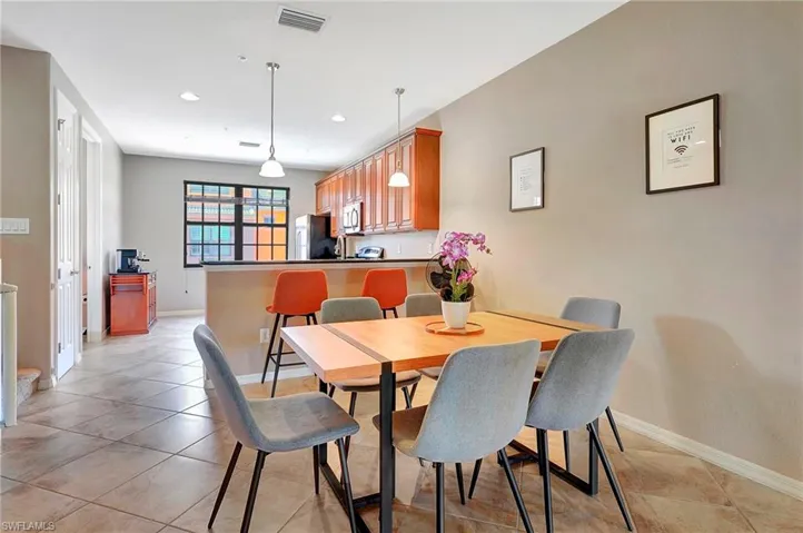 Dining room featuring light tile patterned floors and recessed lighting