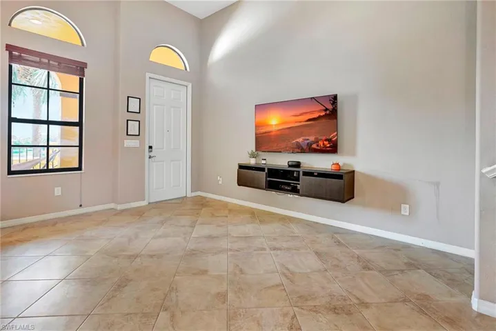 Entrance foyer featuring baseboards and a high ceiling