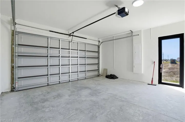 Garage with a garage door opener and electric panel