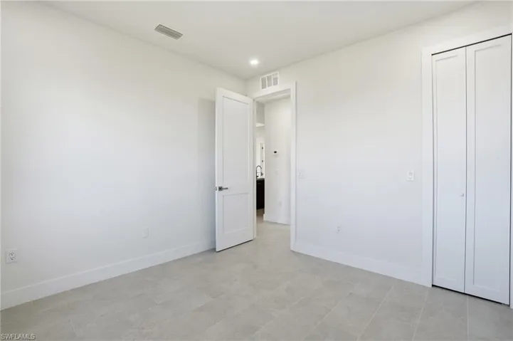 Unfurnished bedroom featuring baseboards and recessed lighting
