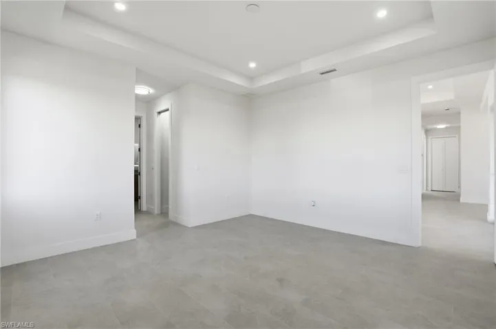 Master Bedroom with a raised ceiling and recessed lighting