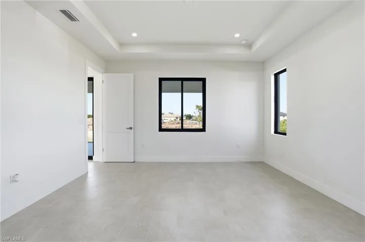 Master Bedroom featuring a raised ceiling and recessed lighting