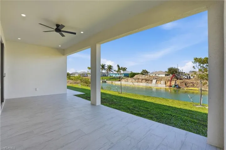 View of patio / terrace featuring ceiling fan, a water view, and a residential view