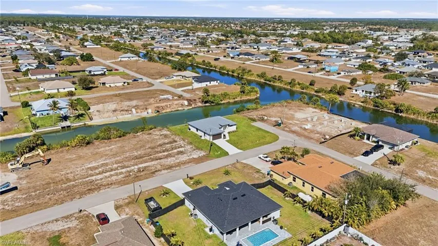 Aerial view of residential area featuring a nearby body of water
