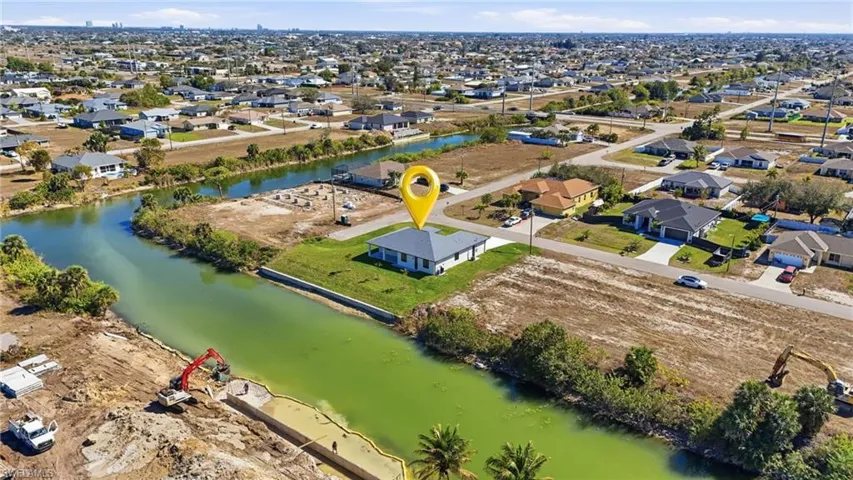 Aerial overview of property's location with nearby suburban area and a nearby body of water