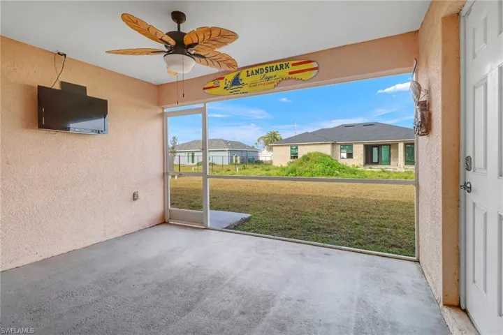 Unfurnished sunroom featuring ceiling fan