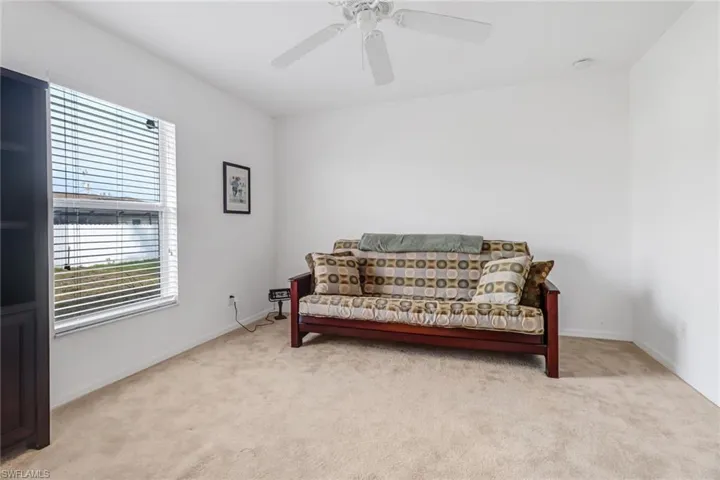 Sitting room featuring light carpet and ceiling fan